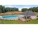Community pool with sundeck and shaded lounge area, perfect for relaxation at 1404 Gray Branch Dr, Lawrenceville, GA 30045