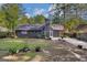 Back exterior view showing a well-maintained yard, patio, and the house facade at 113 Caldwell Dr, Hampton, GA 30228