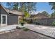 View of the backyard patio area with mature landscaping and trees, surrounded by a wood fence at 113 Caldwell Dr, Hampton, GA 30228