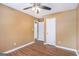 Bedroom featuring laminate flooring, ceiling fan, closet, and white doors at 113 Caldwell Dr, Hampton, GA 30228