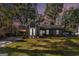 Charming home featuring stone accents, a covered carport, a well-manicured lawn, and tasteful landscaping at 113 Caldwell Dr, Hampton, GA 30228