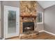 Living room featuring a stone fireplace with wooden mantle and laminate floors at 113 Caldwell Dr, Hampton, GA 30228
