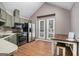 Kitchen with stainless steel appliances, laminate floors, and plenty of natural light at 113 Caldwell Dr, Hampton, GA 30228