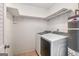 A laundry room with a washer, dryer, and shelving for extra storage at 113 Caldwell Dr, Hampton, GA 30228