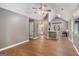 Open-concept living room with high ceilings, laminate floors, and a view of the kitchen at 113 Caldwell Dr, Hampton, GA 30228