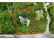 Aerial view of property lines, home with pool nestled in lush greenery, bordering a road and other homes at 1460 Bakers Bridge Rd, Douglasville, GA 30134