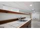 Basement bar area featuring stainless steel sink and wood trim at 1460 Bakers Bridge Rd, Douglasville, GA 30134