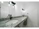 Bathroom featuring double vanity with a white speckled countertop and silver fixtures at 1460 Bakers Bridge Rd, Douglasville, GA 30134