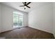 Bright bedroom with a ceiling fan and a large window overlooking the front yard at 1460 Bakers Bridge Rd, Douglasville, GA 30134