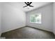 Bright bedroom with a ceiling fan and a window overlooking the backyard at 1460 Bakers Bridge Rd, Douglasville, GA 30134