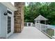 The deck area features a stone fireplace, white railings, and a gazebo overlooking the backyard at 1460 Bakers Bridge Rd, Douglasville, GA 30134