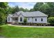 Charming stucco home with manicured lawn, showcasing a blend of modern design and classic appeal at 1460 Bakers Bridge Rd, Douglasville, GA 30134