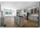 Modern kitchen with granite countertops, an island cooktop, stainless appliances, and wood floors at 1460 Bakers Bridge Rd, Douglasville, GA 30134