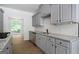 Bright kitchen showcasing granite counters, stainless steel appliances, and a subway tile backsplash at 1460 Bakers Bridge Rd, Douglasville, GA 30134