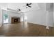 Open-concept living room with wood floors, brick fireplace, tray ceiling and bright natural light at 1460 Bakers Bridge Rd, Douglasville, GA 30134