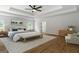 Cozy main bedroom with sitting area, ceiling fan, tray ceiling, and plenty of natural light at 1460 Bakers Bridge Rd, Douglasville, GA 30134