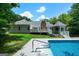 A spacious pool with a diving board is the focal point of this backyard, complemented by a gazebo at 1460 Bakers Bridge Rd, Douglasville, GA 30134