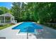 A vibrant blue pool is surrounded by green trees and a gazebo, creating a private oasis at 1460 Bakers Bridge Rd, Douglasville, GA 30134