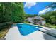 Relax by the pool with diving board and views of the home and the screened in gazebo at 1460 Bakers Bridge Rd, Douglasville, GA 30134