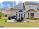 Spacious backyard patio featuring outdoor seating, grill, lush green lawn, and easy access to the home at 1602 Cascade Overlook, Peachtree City, GA 30269