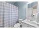 Bathroom featuring a toilet, sink, vanity, and shower with blue and white shower curtain at 1602 Cascade Overlook, Peachtree City, GA 30269
