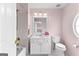 Bathroom featuring a white vanity, toilet, bathtub with shower, and decorative mirror at 1602 Cascade Overlook, Peachtree City, GA 30269