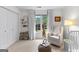 Bright bedroom with a white chair, storage, and a window for ample natural light at 1602 Cascade Overlook, Peachtree City, GA 30269