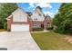 Charming front exterior of a well-maintained two-story brick and siding home with a manicured lawn at 1602 Cascade Overlook, Peachtree City, GA 30269
