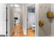 Hallway view showcasing the bathroom and kitchen areas, with wooden floors and neutral walls at 1602 Cascade Overlook, Peachtree City, GA 30269
