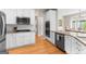 Bright kitchen featuring white cabinets, granite countertops, stainless appliances, and hardwood floors at 1602 Cascade Overlook, Peachtree City, GA 30269
