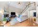 Open living room showcasing hardwood floors, staircase, fireplace, and ceiling fan at 1602 Cascade Overlook, Peachtree City, GA 30269