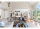 Open-concept living room with view of the dining area, hardwood floors, and large windows at 1602 Cascade Overlook, Peachtree City, GA 30269