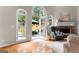 Elegant living room with stone fireplace, hardwood floors, and access to the outdoor patio at 1602 Cascade Overlook, Peachtree City, GA 30269