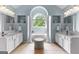 Bright main bathroom with double sinks, a bathtub, and a window at 1602 Cascade Overlook, Peachtree City, GA 30269