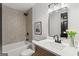 Well-lit bathroom showing shower with tile surround, bathtub, and vanity with a large mirror at 1239 Teakwood Trl, Stone Mountain, GA 30083
