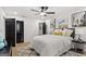 Cozy bedroom featuring an overhead ceiling fan, wood-look floors, modern art, and a gray rug at 1239 Teakwood Trl, Stone Mountain, GA 30083