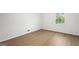 Clean, airy bedroom featuring double-paned window and wood-look flooring at 1239 Teakwood Trl, Stone Mountain, GA 30083