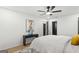 Bright bedroom with wood-look floors, ceiling fan, modern art and a black accent door at 1239 Teakwood Trl, Stone Mountain, GA 30083