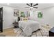Comfortable bedroom with a ceiling fan, decorative wall art and bright sunlight at 1239 Teakwood Trl, Stone Mountain, GA 30083