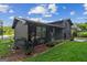 A side and rear view of the black brick house with a lawn and garden bed at 1239 Teakwood Trl, Stone Mountain, GA 30083