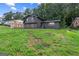 Charming two-story home with a black brick exterior and lush green lawn at 1239 Teakwood Trl, Stone Mountain, GA 30083