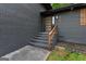 A close up of the front door with black brick, wooden steps and hand rail at 1239 Teakwood Trl, Stone Mountain, GA 30083