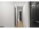 Hallway featuring multiple doors and access points to different rooms, all with modern flooring at 1239 Teakwood Trl, Stone Mountain, GA 30083