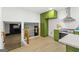 Open kitchen with olive green cabinets, stainless steel appliances, and a view of the living area at 1239 Teakwood Trl, Stone Mountain, GA 30083