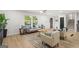 Open living room with comfortable seating, warm lighting, and hardwood floors at 1239 Teakwood Trl, Stone Mountain, GA 30083