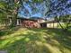 View of home's backyard featuring a covered carport and brick exterior at 2670 Foxlair Trl, South Fulton, GA 30349