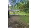 Spacious backyard features a covered patio, mature trees, and lush green grass at 2670 Foxlair Trl, South Fulton, GA 30349