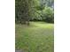 Large, grassy backyard, partially fenced, provides ample space for outdoor activities and gardening at 2670 Foxlair Trl, South Fulton, GA 30349