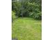 The backyard is a natural retreat with its mature trees and lush green grass at 2670 Foxlair Trl, South Fulton, GA 30349