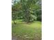 Large backyard with mature trees and lush green grass, perfect for outdoor activities and relaxation at 2670 Foxlair Trl, South Fulton, GA 30349